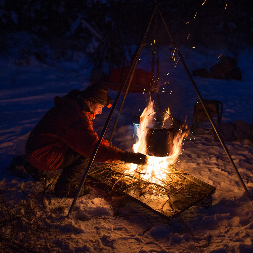 Winter cooking on a Boundary Waters Dog Sledding & Cross Country Skiing for Adults expedition