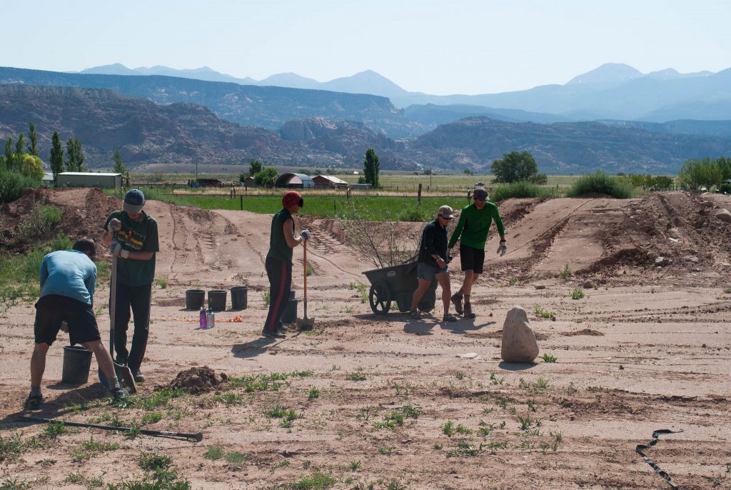 Photo shows Outward Bound students completing a service project on a Pathfinder expedition, courtesy of Kelly Crandall.