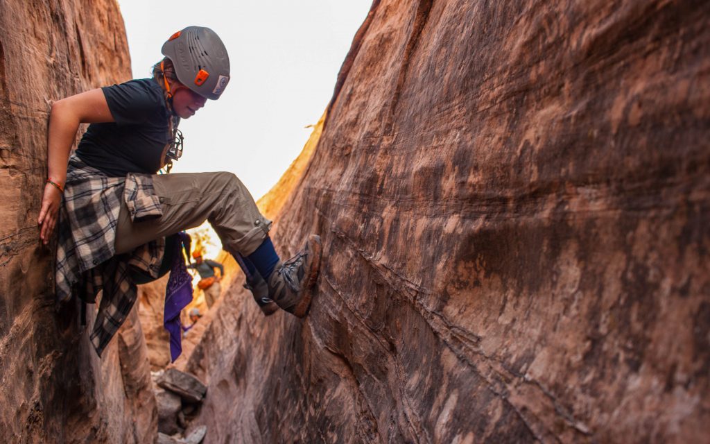 Photo shows a student learning cayoneering skills on a Pathfinder Southwest Rafting & Canyon Backpacking expedition, courtesy of Steve Creech.